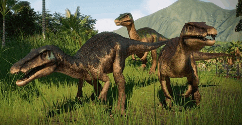a group of dinosaurs are walking in the grass