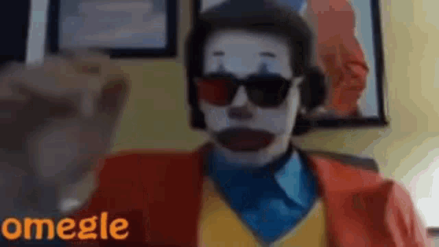 a man dressed as a clown with sunglasses and a headset is talking on omegle .