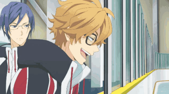 a man with glasses stands next to another man