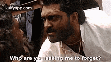 a man with a beard is talking to another man .