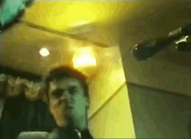 a blurry picture of a man taking a selfie