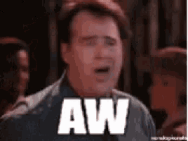 a man is making a funny face and the word aw is on his face .