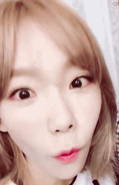 a close up of a woman making a funny face with her mouth open