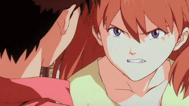 a boy and a girl are looking at each other and the girl is angry