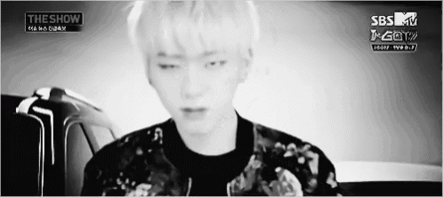 a black and white photo of a young man with a sbs tv logo on the bottom