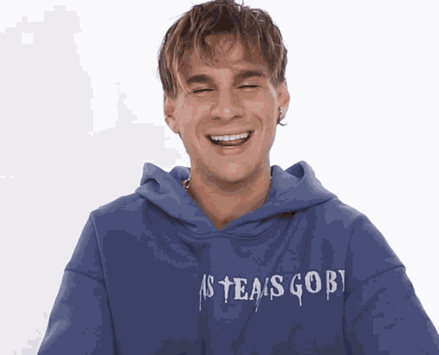 a man wearing a hoodie that says ' sgob ' on it is laughing