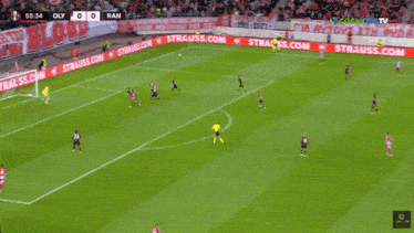 a soccer game is being played in front of a banner that says " blood "