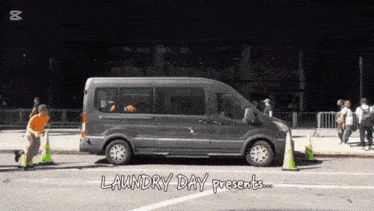 a gray van is parked on the side of the road with the words laundry day presents