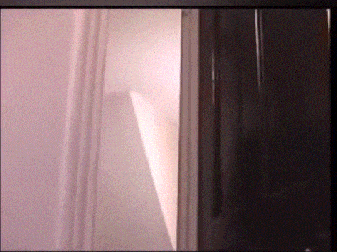 a door is open to a room with a pink wall