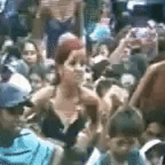 a crowd of people are gathered together in a blurred photo