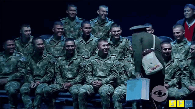 a group of soldiers are posing for a picture with a woman holding a bag that says " marcela "