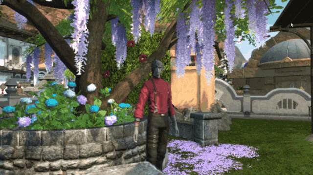 a man in a red shirt is standing next to a tree with purple flowers