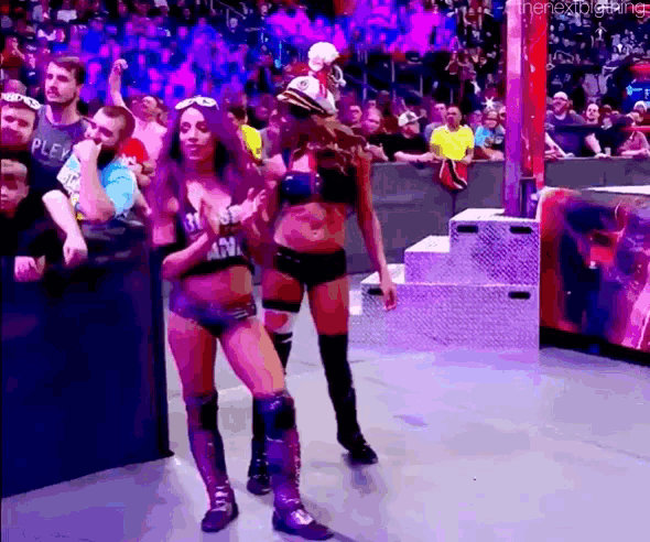 a couple of women standing next to each other on a stage .
