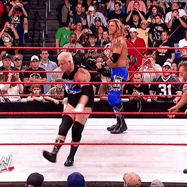 two wrestlers in a ring with the number 31 on the back of their jersey