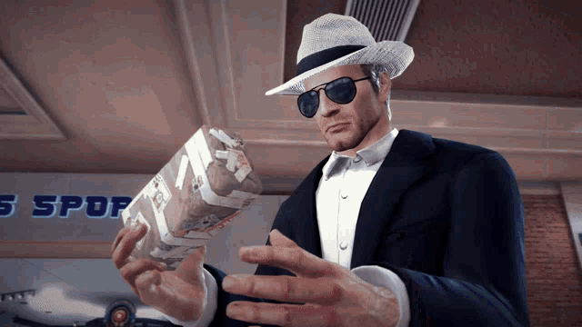 a man in a tuxedo and hat holds a box in front of a sign that says spor