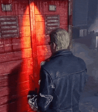 a man in a blue leather jacket is standing in front of a red door
