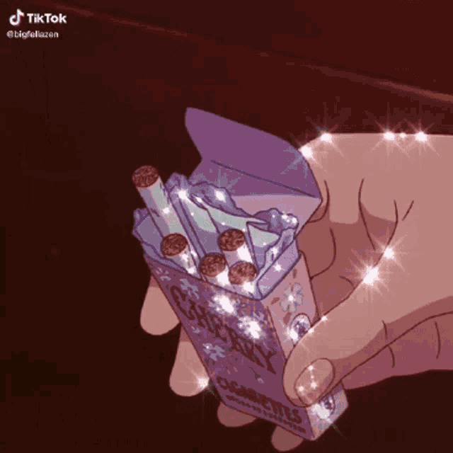 a person is holding a box of cigarettes in their hands