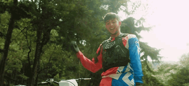 a man wearing a red white and blue fox racing shirt