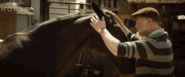 a man petting a horse with a dream horse advertisement in the background