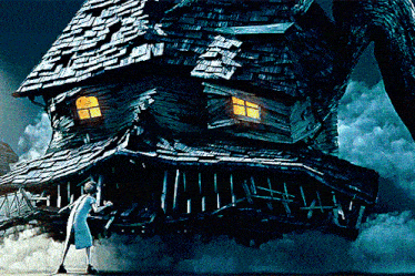 a woman is standing in front of a very large house