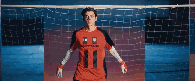 a soccer player wearing a number 11 jersey stands in front of a goal