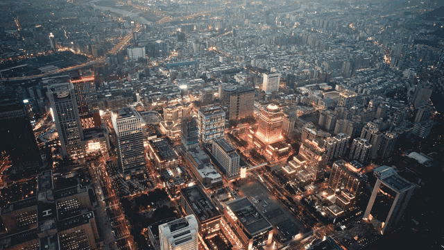 an aerial view of a city at night with a few buildings that have the letter h on them