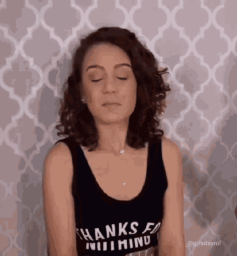 a woman wearing a black tank top that says thanks for nothing