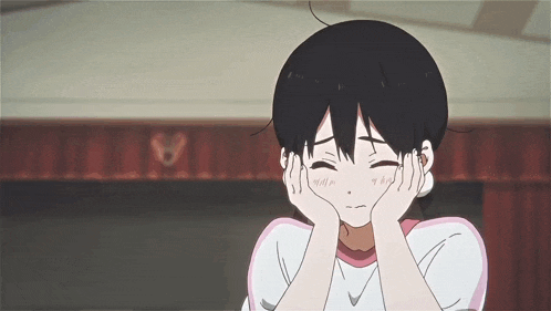 a girl is covering her ears with her hands while making a sad face .