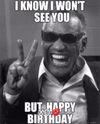 a man wearing sunglasses and a suit is giving a peace sign