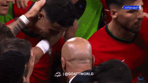 a group of soccer players are huddled together with the words goattworld in the upper right corner