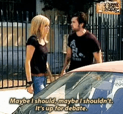 a man and a woman standing next to a car with maybe i should maybe i shouldn 't