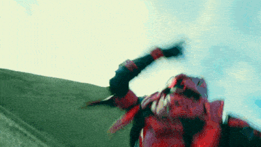 a person in a red superhero costume is flying through the air