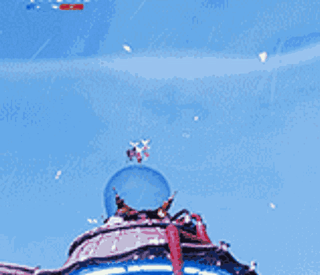 a blue object with a crown on top of it in the sky