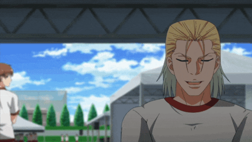 a man with blonde hair and a red collar smiles with his eyes closed