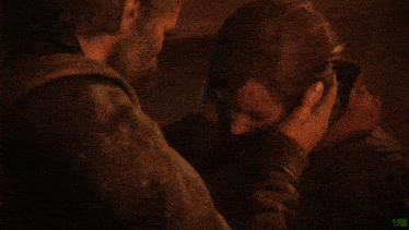 a man holds a woman 's face and says " ellie he tried to "