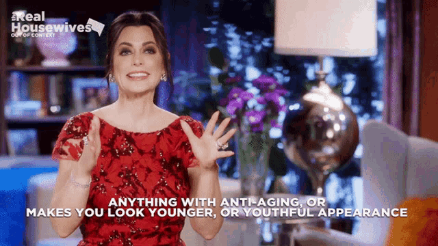 a woman in a red dress says " anything with anti-aging or makes you look younger "