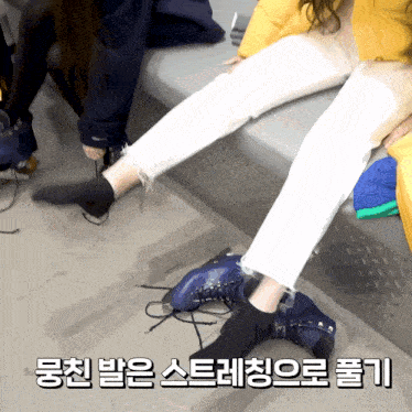 a person sitting on a bench with a pair of blue skates on their feet