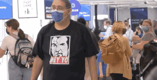 a man wearing a black shirt that says hey yo on it