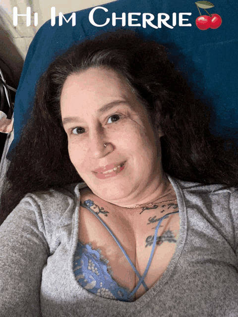 a woman laying on a bed with the words hi im cherrie written above her