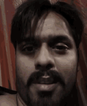 a man with a beard is making a funny face with his mouth open