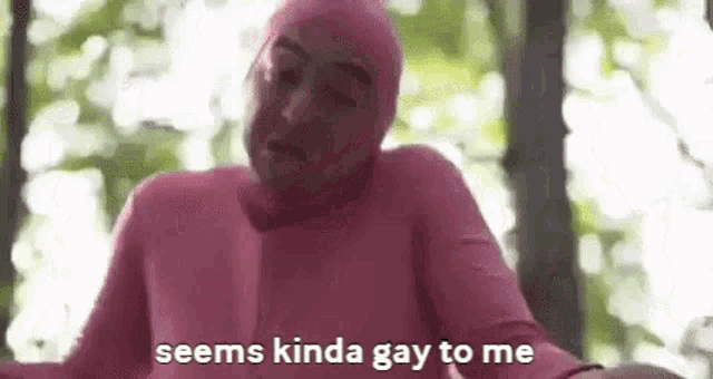 a man in a pink suit is talking to someone .