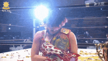 a woman in a wrestling ring with the hashtag #pwmg on the bottom