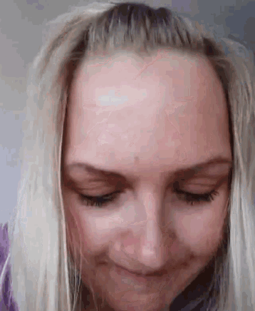 a close up of a woman 's face with a smile on her face