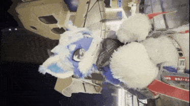 a person in a furry costume is standing in front of a building at night .