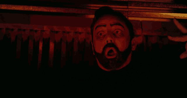 a man with a beard is looking up at something