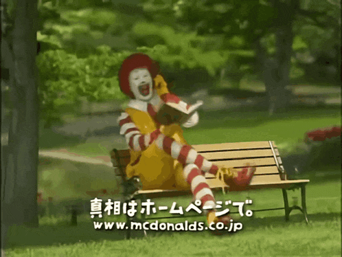 a mcdonald 's advertisement shows a clown sitting on a bench reading a book