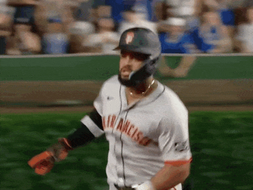 a baseball player wearing a san francisco jersey is walking on the field