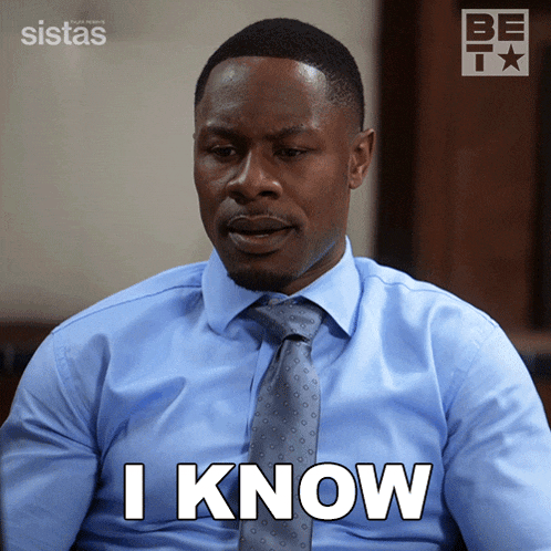 a man in a blue shirt and tie has the word i know on his face