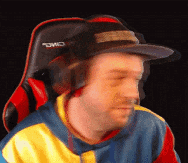 a blurry image of a man wearing headphones and a hat with the word omo on it