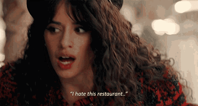 a woman says " i hate this restaurant " in a close up